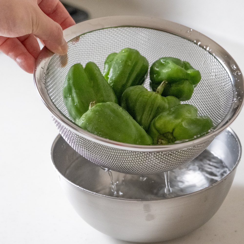 A deep bowl and a colander that won't let rice fall through